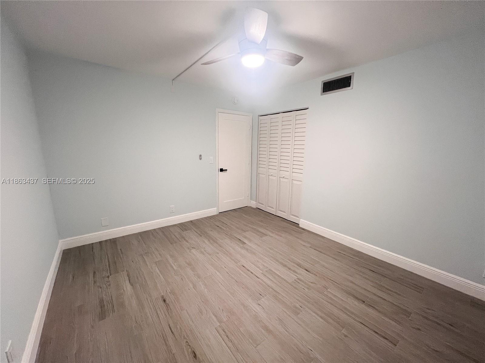 769 Jeffery Street, Unit 2205 Boca Raton, FL 33487 - Photo 11 of 30 wooden floor in an empty room with a window