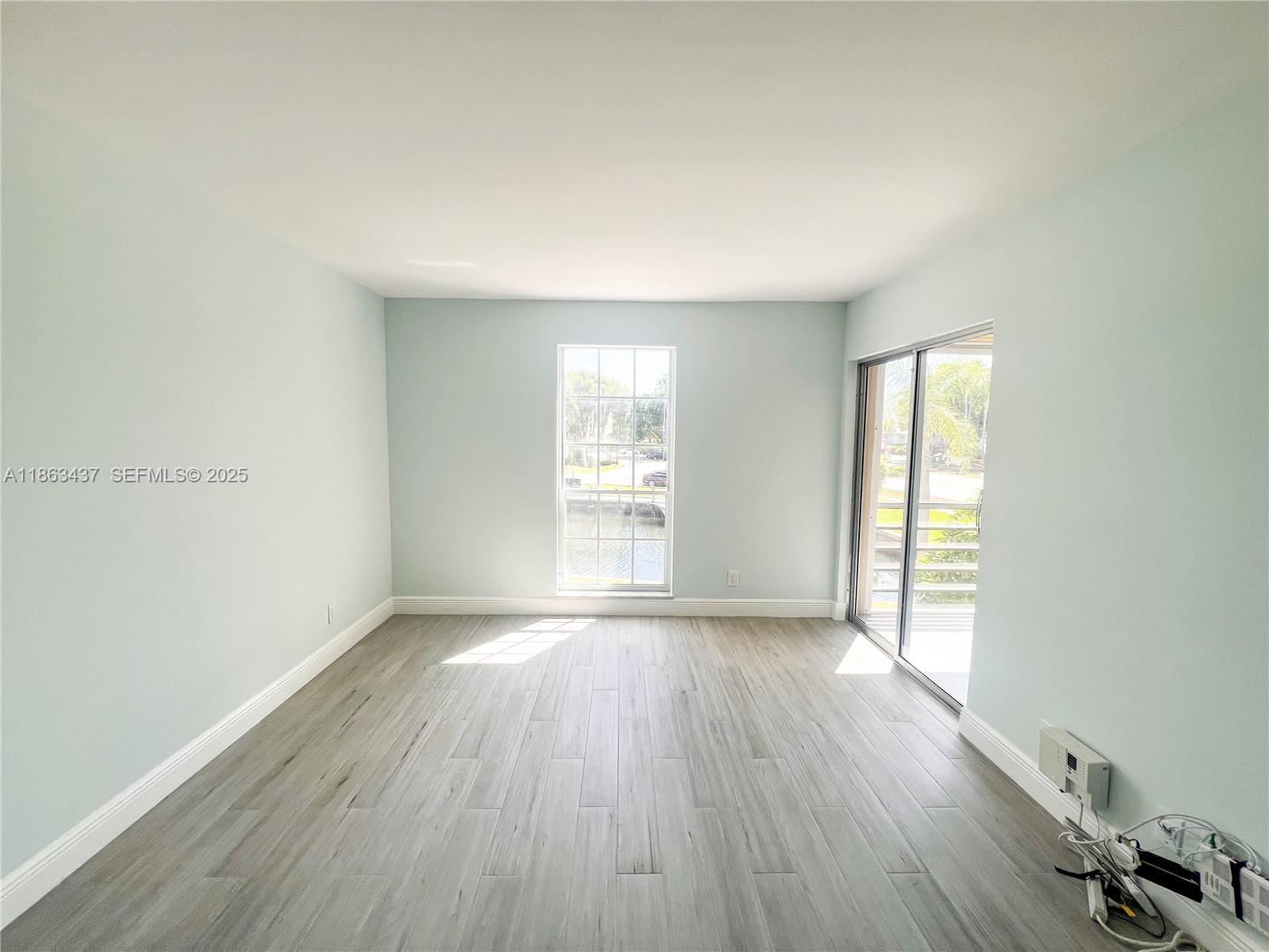 769 Jeffery Street, Unit 2205 Boca Raton, FL 33487 - Photo 13 of 30 an empty room with wooden floor and windows