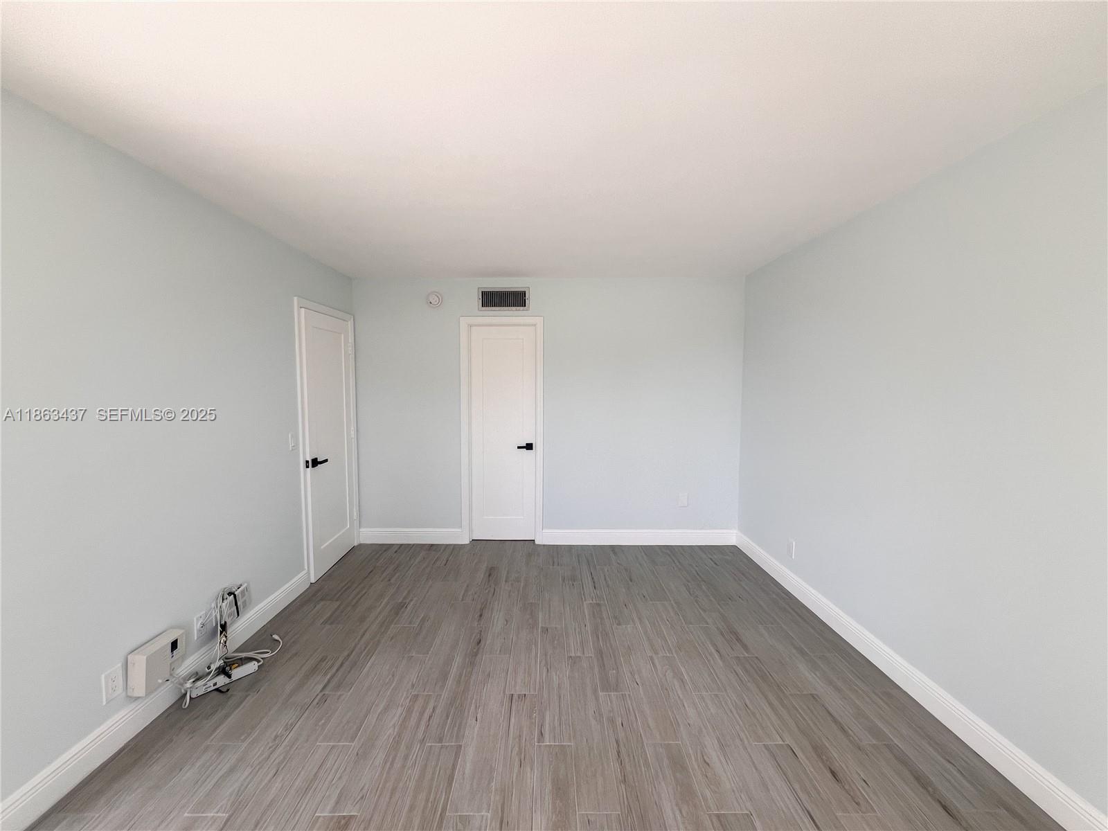 769 Jeffery Street, Unit 2205 Boca Raton, FL 33487 - Photo 14 of 30 a view of an empty room and wooden floor