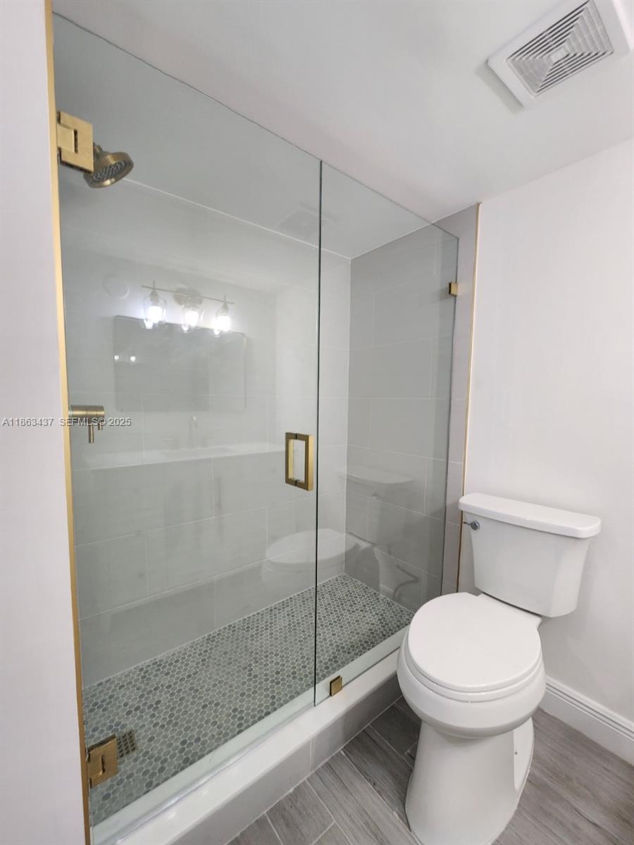 769 Jeffery Street, Unit 2205 Boca Raton, FL 33487 - Photo 19 of 30 a bathroom with a toilet and a shower