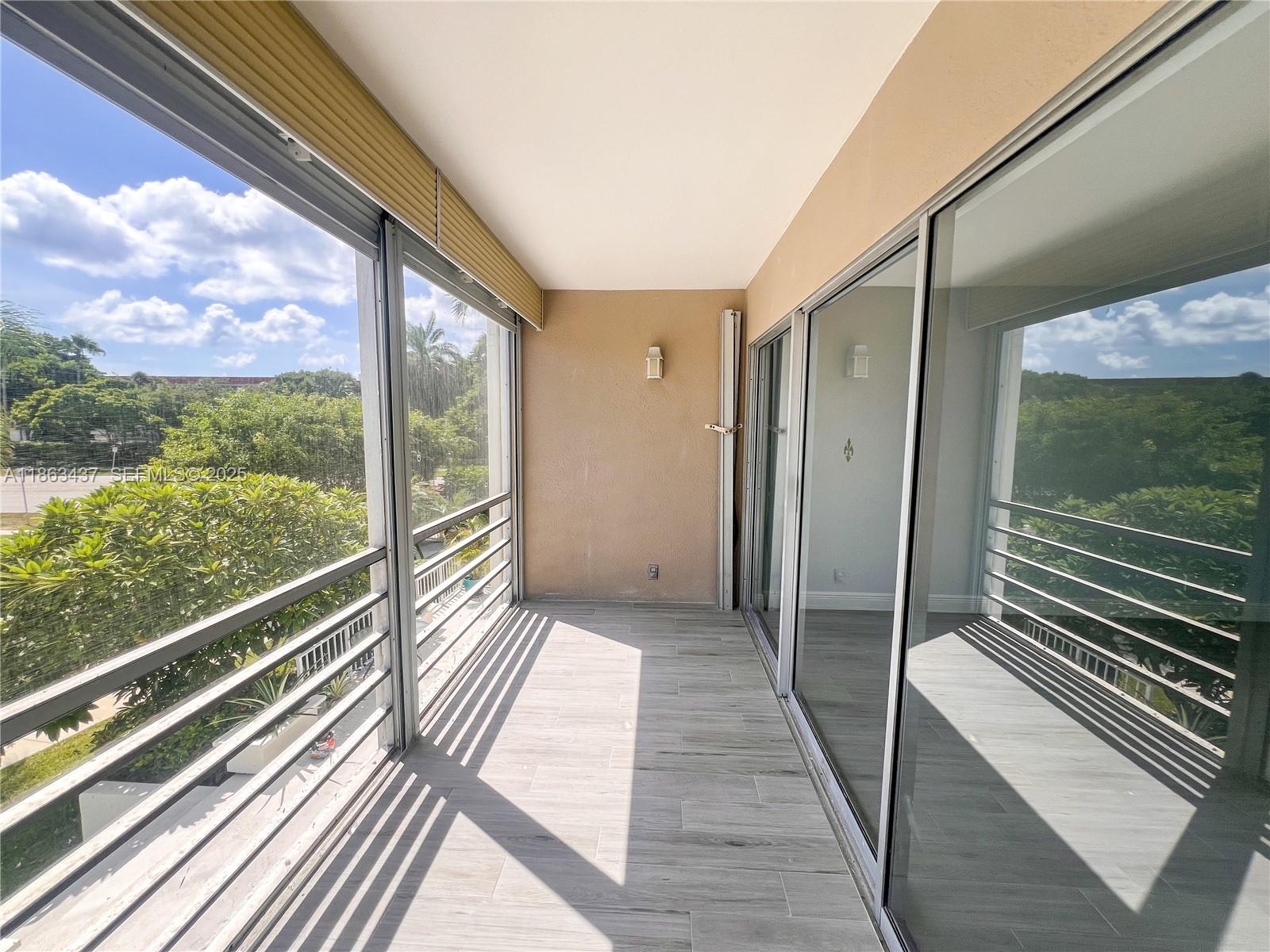 769 Jeffery Street, Unit 2205 Boca Raton, FL 33487 - Photo 21 of 30 a view of balcony with floor to ceiling windows with wooden floor