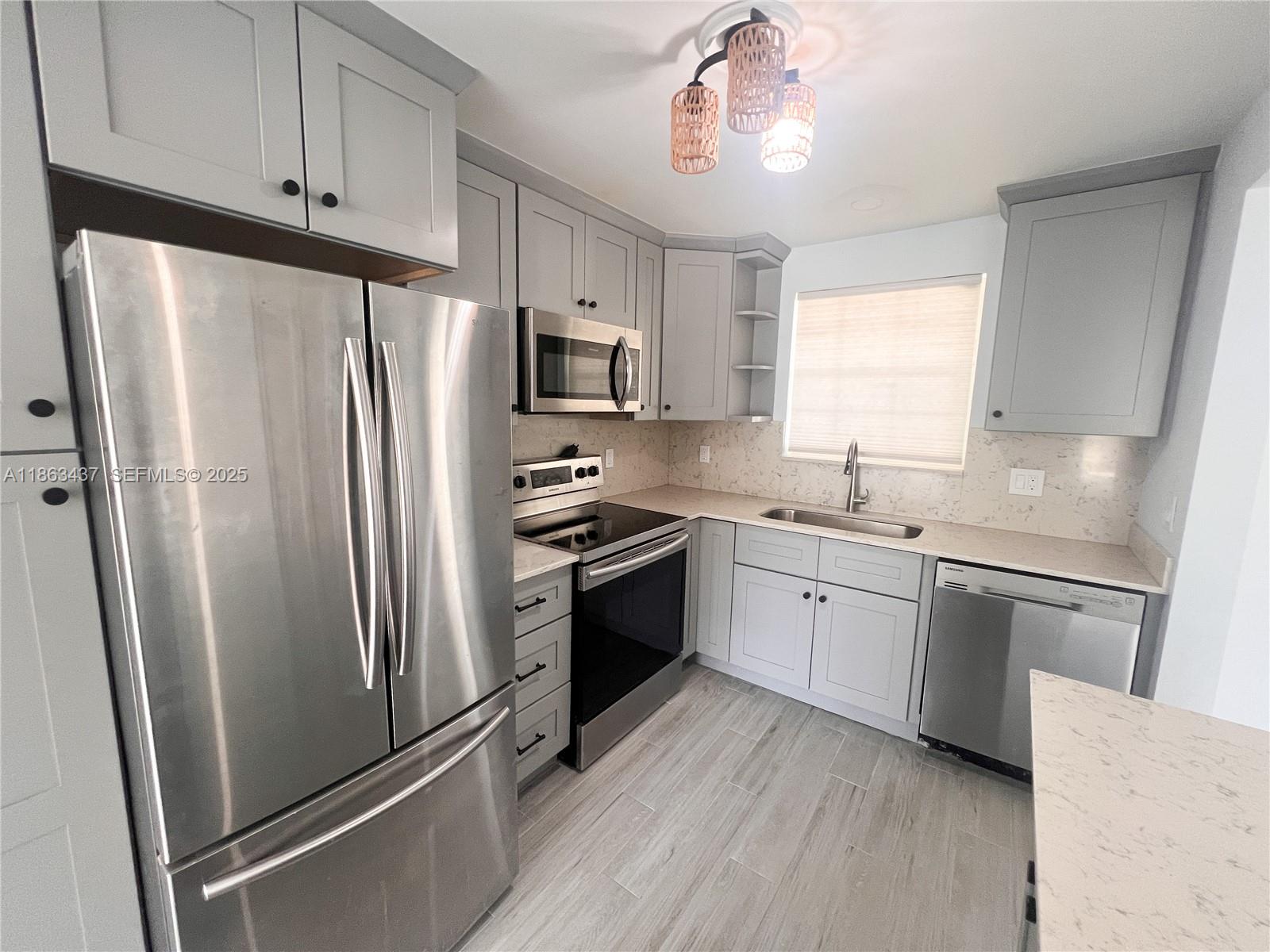 769 Jeffery Street, Unit 2205 Boca Raton, FL 33487 - Photo 3 of 30 a kitchen with stainless steel appliances a refrigerator sink and microwave