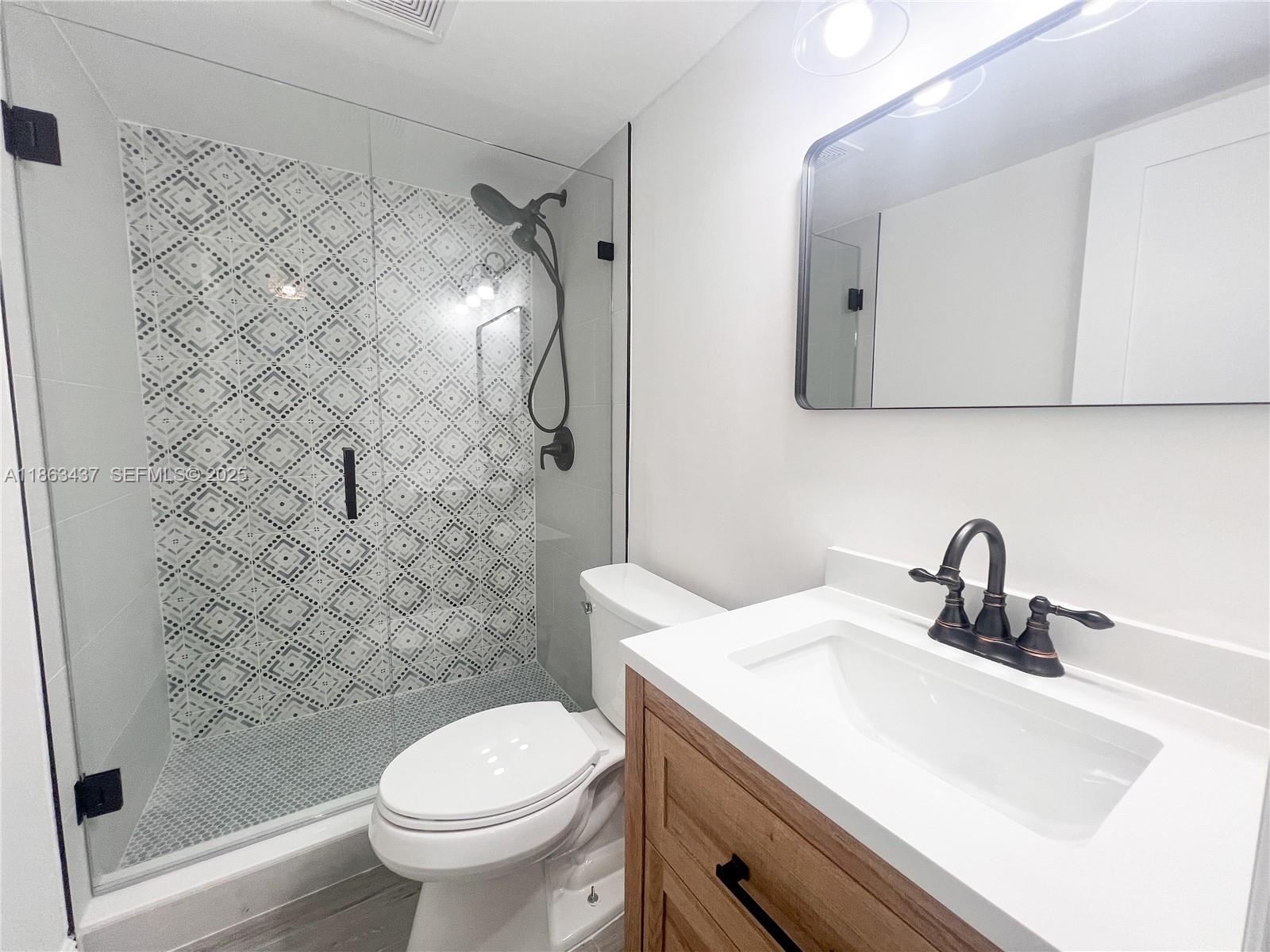 769 Jeffery Street, Unit 2205 Boca Raton, FL 33487 - Photo 7 of 30 a bathroom with a sink toilet and shower