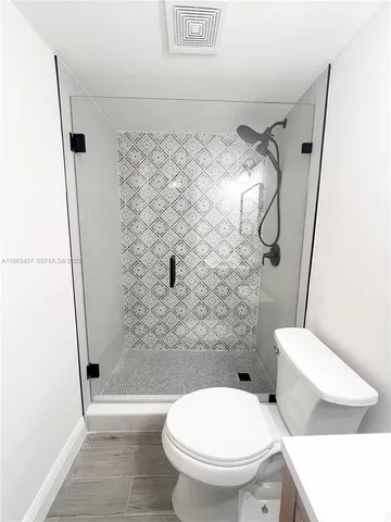 a bathroom with a toilet and a shower
