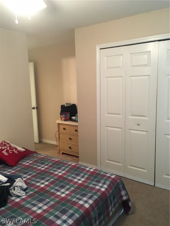 941 Homestead Road South, Unit 941/943 Lehigh Acres, FL 33974 - Photo 17 of 19 a bedroom with a bed and cabinets