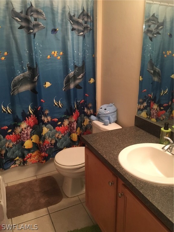 941 Homestead Road South, Unit 941/943 Lehigh Acres, FL 33974 - Photo 7 of 19 a bathroom with a sink toilet and a mirror
