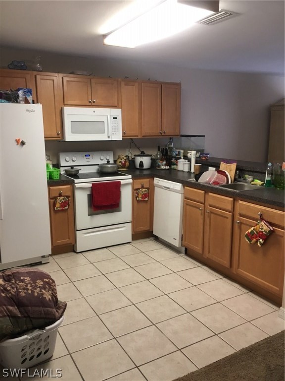 941 Homestead Road South, Unit 941/943 Lehigh Acres, FL 33974 - Photo 9 of 19 a kitchen with stainless steel appliances a stove a sink and a refrigerator