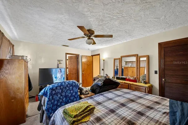 a bedroom with two beds and a walk in closet