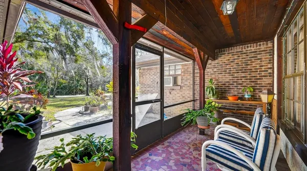a yellow and red house with trees in front of it
