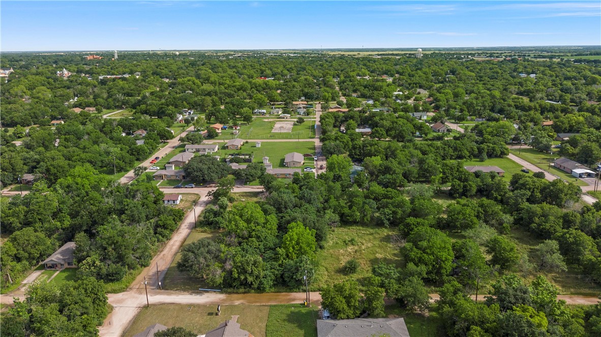 703 Stringfellow Avenue Marlin, TX 76661 - Photo 11 of 11 an aerial view of residential houses with outdoor space and trees