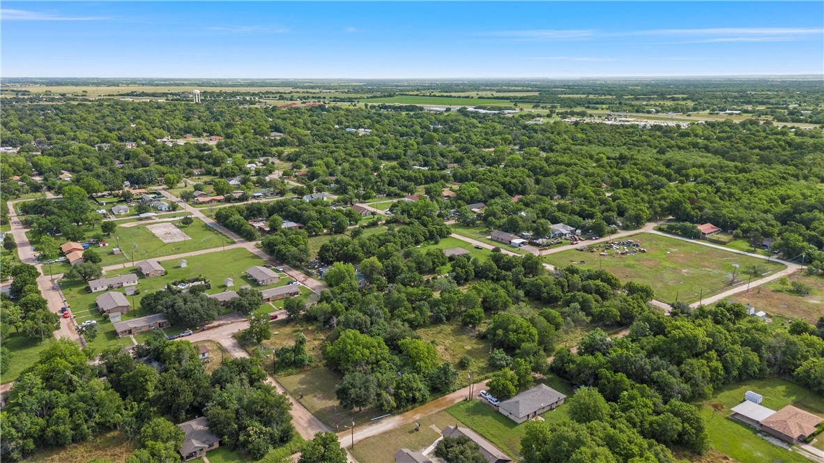 703 Stringfellow Avenue Marlin, TX 76661 - Photo 7 of 11 an aerial view of residential houses with outdoor space and trees