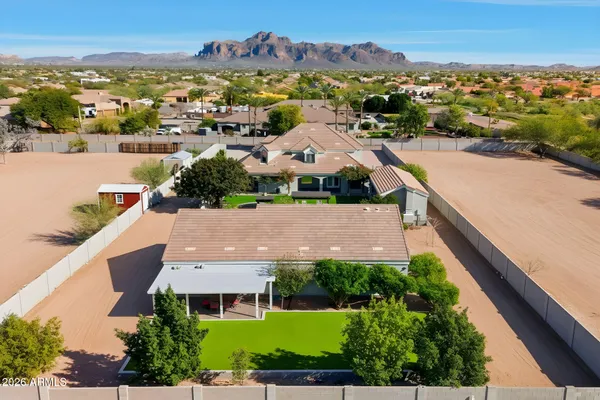 an aerial view of residential houses with outdoor space and ocean view
