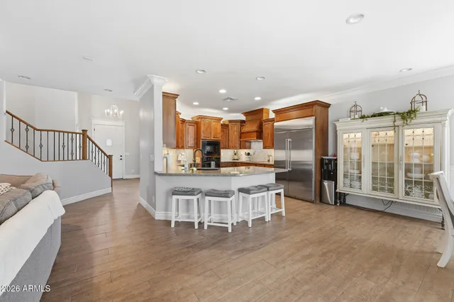a bathroom with a granite countertop sink a toilet and a mirror