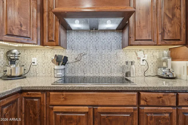 a bathroom with a granite countertop sink a mirror and a shower