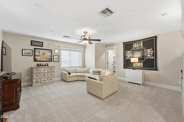 a view of a dining room and livingroom with furniture wooden floor and a rug