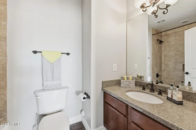 a kitchen with stainless steel appliances granite countertop a refrigerator a sink dishwasher a stove and a oven with wooden floor