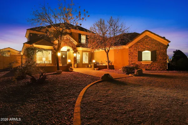 a front view of a house with a yard table and chairs