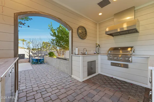 a backyard of a house with plants and wooden fence