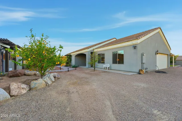 an aerial view of residential houses with outdoor space and trees