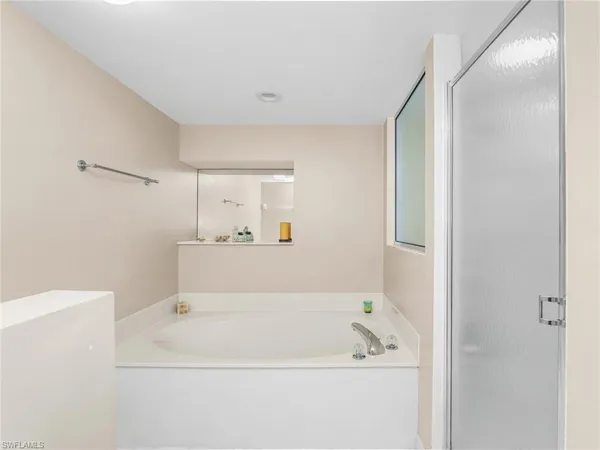 a bathroom with a sink a toilet a mirror and shower