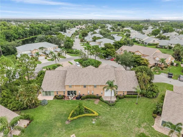 an aerial view of residential houses with outdoor space and river