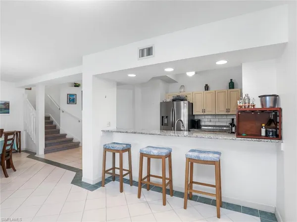 a large kitchen with a table and chairs