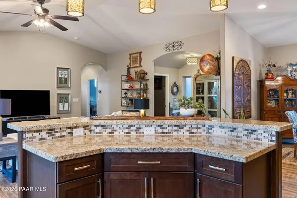 a bathroom with a granite countertop double vanity and a mirror
