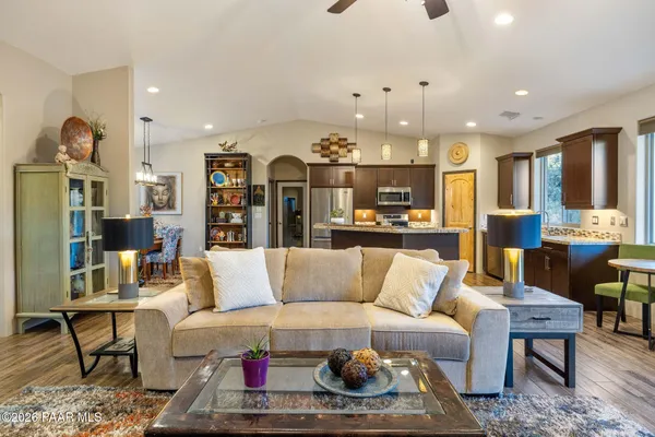 a large kitchen with a center island and stainless steel appliances