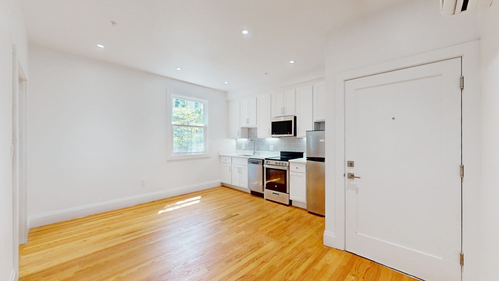 21 Regent Circle, Unit 3 Brookline, MA 02445 - Photo 5 of 21 a view of kitchen with furniture and wooden floor