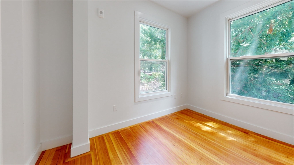 21 Regent Circle, Unit 3 Brookline, MA 02445 - Photo 9 of 21 a view of a room with wooden floor and a window