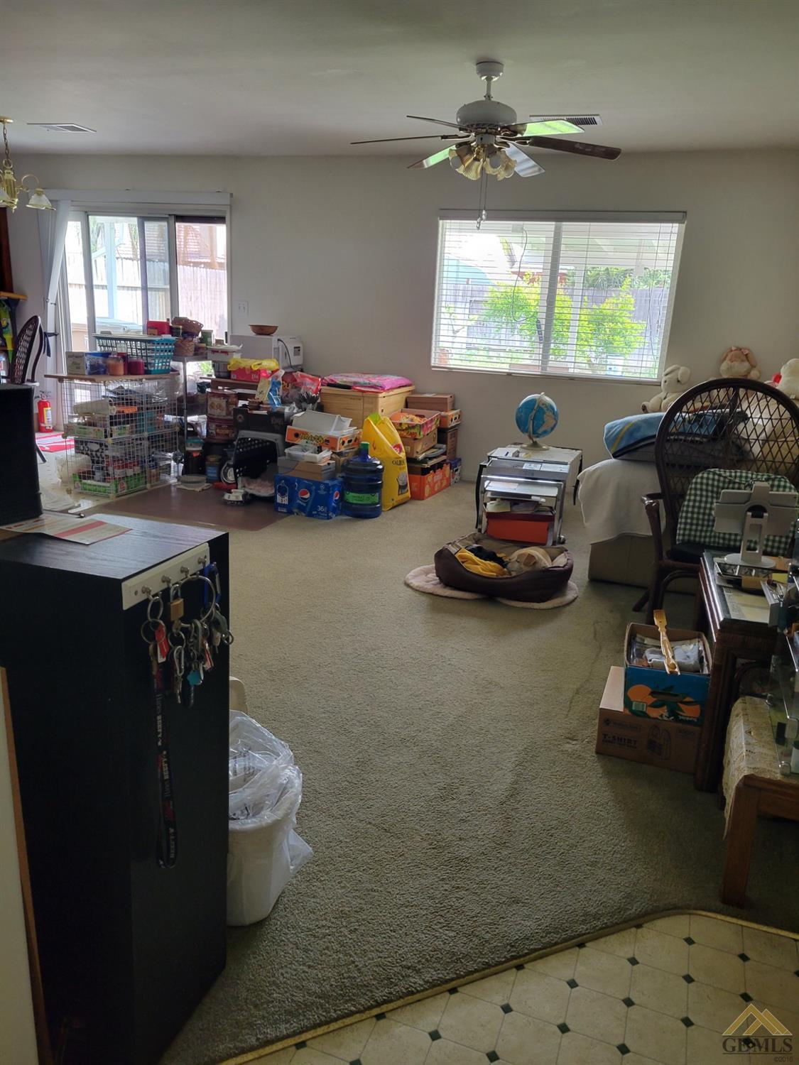 Undisclosed Address Bakersfield, CA 93311 - Photo 4 of 9 a gym hall with furniture a window and a chandelier