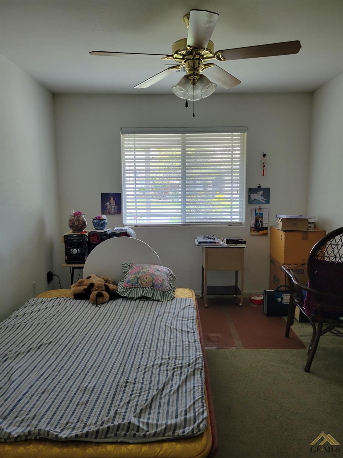 Undisclosed Address Bakersfield, CA 93311 - Photo 7 of 9 a bedroom with a bed and a window