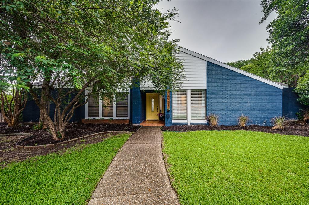 12928 Jennifer Place Dallas, TX 75243 - Photo 1 of 1 a front view of a house with a garden and yard