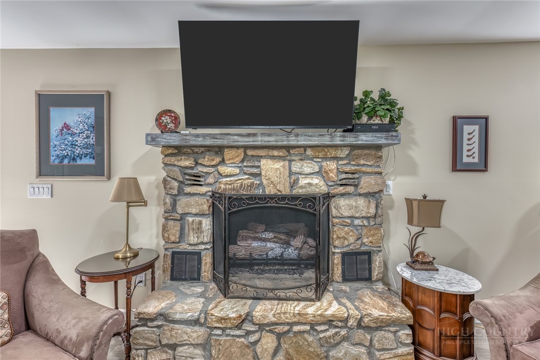 174 Spruce Pine Road Newland, NC 28657 - Photo 16 of 50 a living room with furniture a flat screen tv and a fireplace