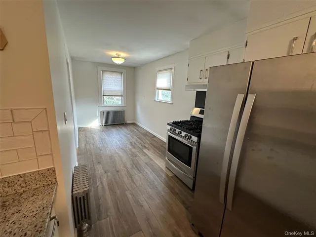 a kitchen with stainless steel appliances a refrigerator and a stove