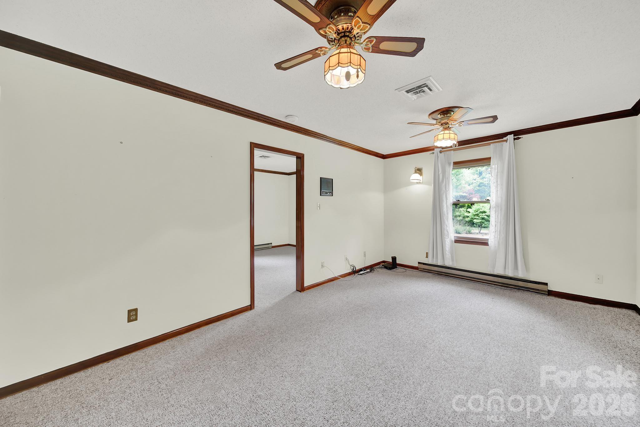 5913 Tom Query Road Charlotte, NC 28213 - Photo 21 of 47 an empty room with windows and fan