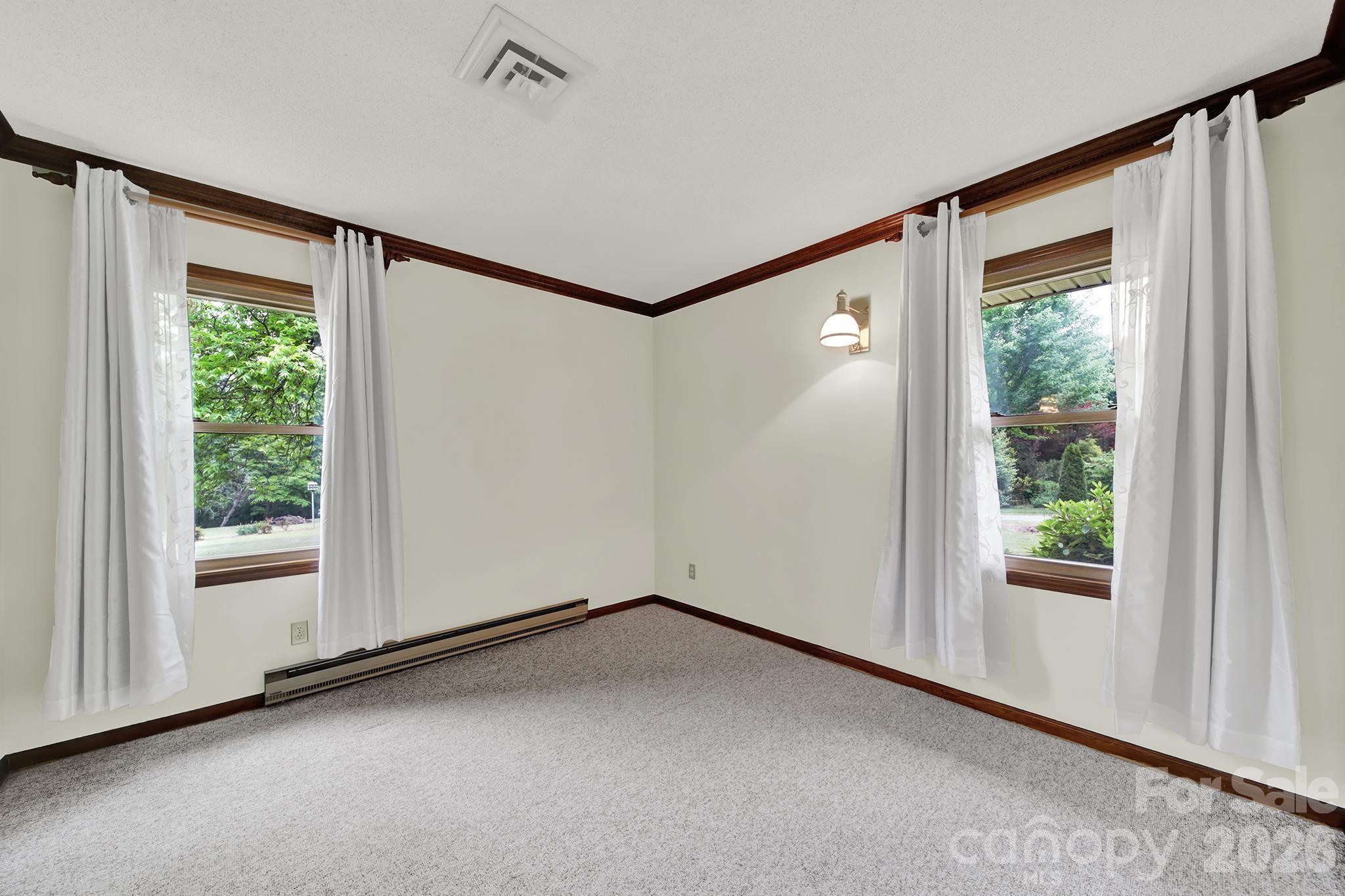 5913 Tom Query Road Charlotte, NC 28213 - Photo 24 of 47 a view of a big room with wooden floor and windows