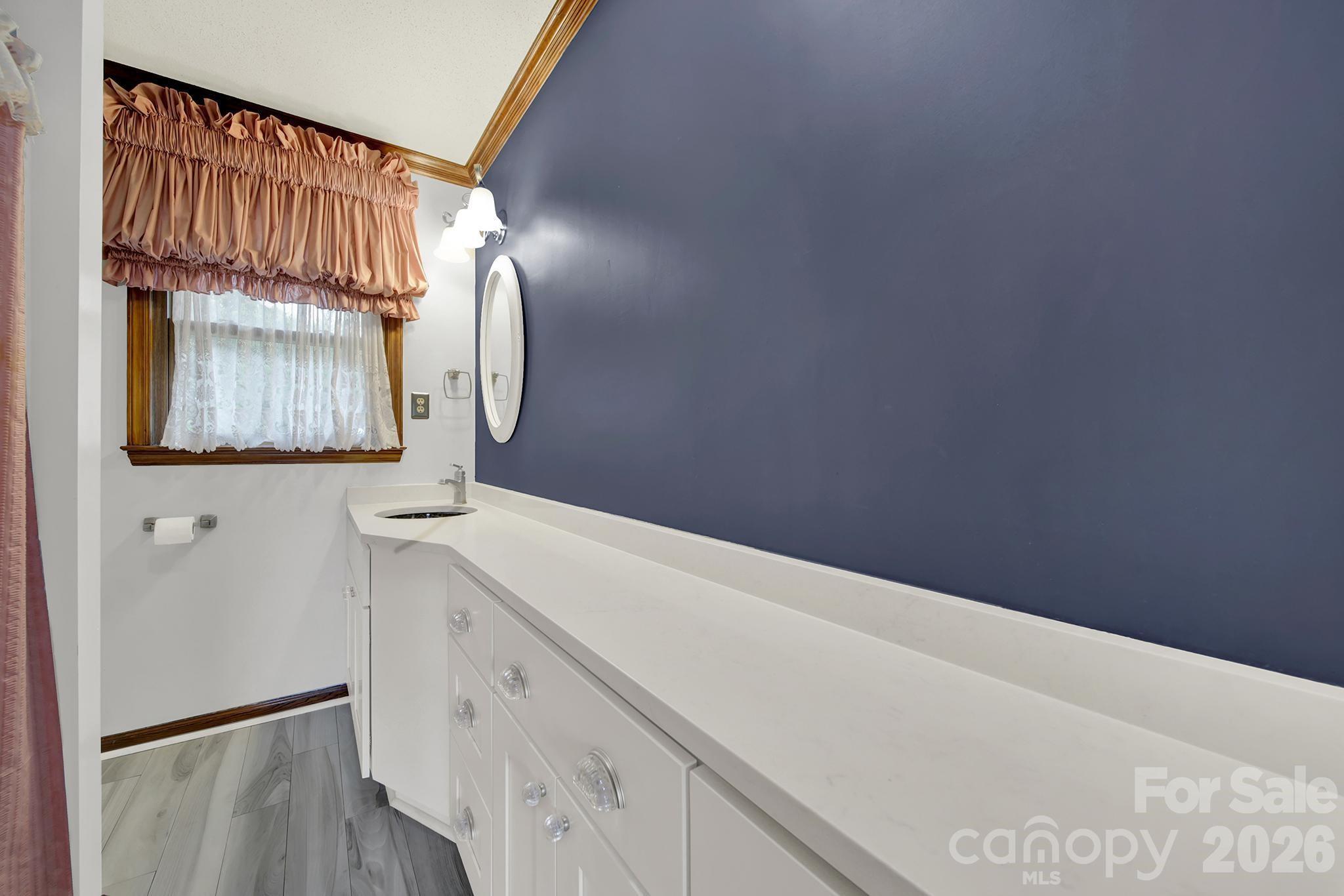 5913 Tom Query Road Charlotte, NC 28213 - Photo 26 of 47 a bathroom with a sink and a mirror