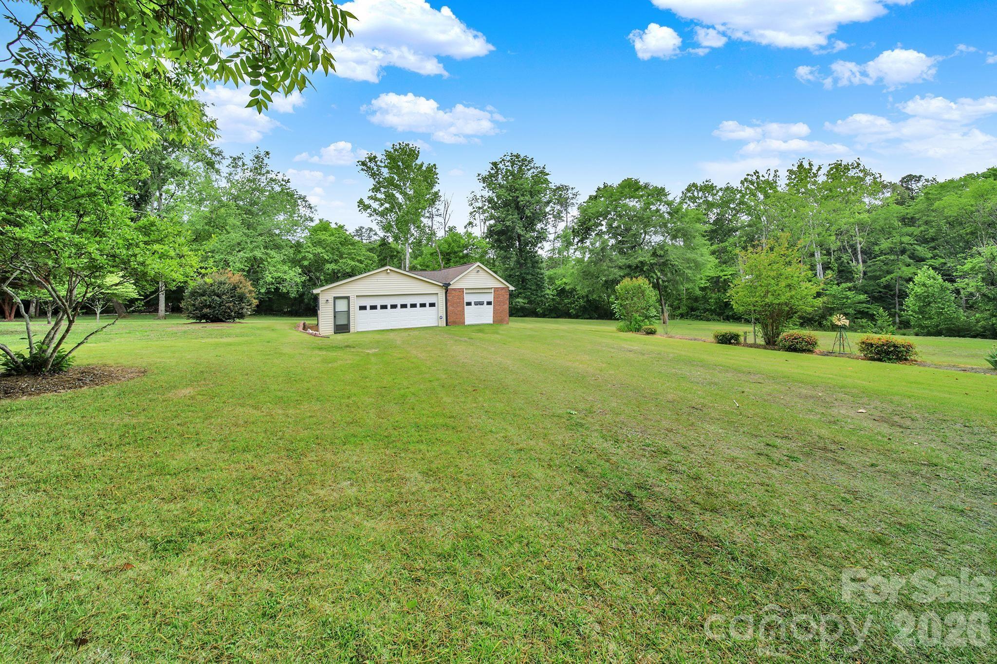 5913 Tom Query Road Charlotte, NC 28213 - Photo 33 of 47 a view of a big yard with a house in the background