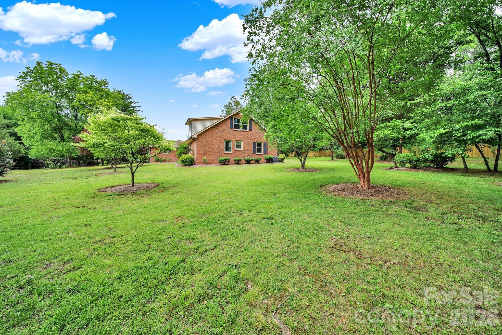 5913 Tom Query Road Charlotte, NC 28213 - Photo 35 of 47 a house with huge green field in front of it