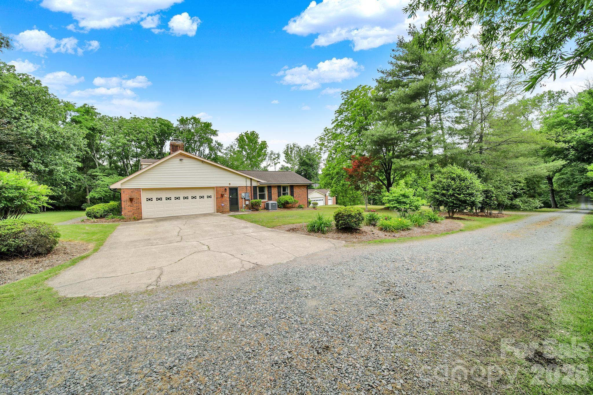 5913 Tom Query Road Charlotte, NC 28213 - Photo 36 of 47 a front view of a house with a yard and garage