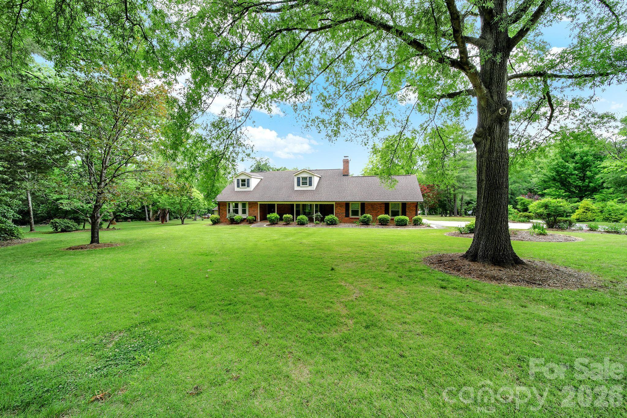 5913 Tom Query Road Charlotte, NC 28213 - Photo 38 of 47 a view of a house with a big yard and large trees