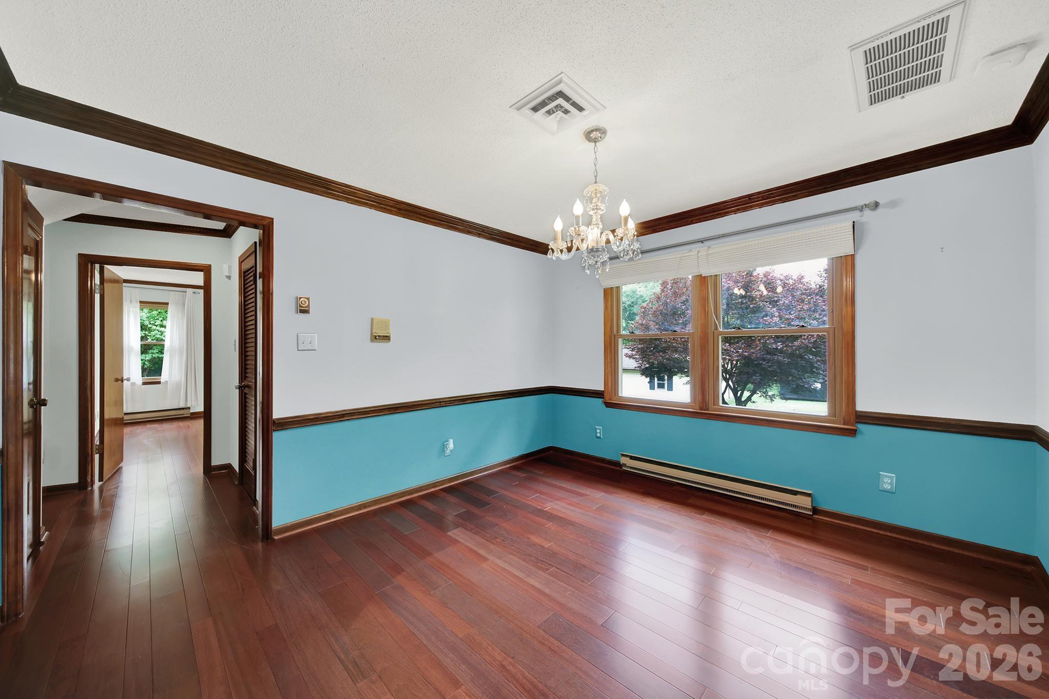 5913 Tom Query Road Charlotte, NC 28213 - Photo 8 of 47 a room with window and wooden floor