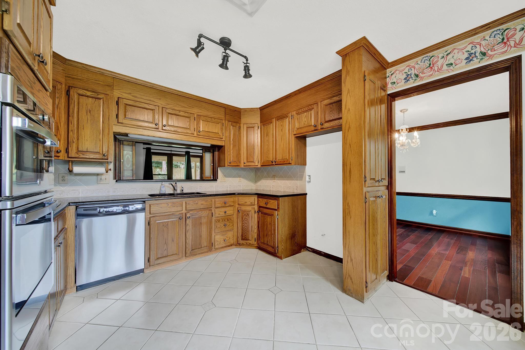 5913 Tom Query Road Charlotte, NC 28213 - Photo 10 of 47 a kitchen with stainless steel appliances granite countertop a refrigerator and a stove top oven