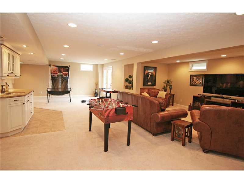 313 Buffalo Ridge Road Canonsburg, PA 15317 - Photo 21 of 25 Basement/Game Room. Bring on the fun!!! The gameroom offers a media area and a bar area, a 5th bedroom (great guest suite), full bath, tons of storage and walk-out access to the patio and rear yard.
