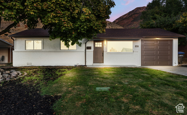 447 South 1450th Street East Provo, UT 84606 - Photo 1 of 1 View of front of property featuring a garage and a yard