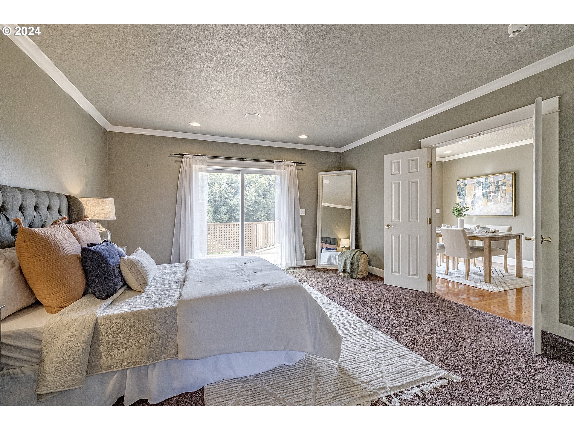 5434 Southeast King Road Milwaukie, OR 97222 - Photo 12 of 33 a bedroom with a large bed and wooden floor