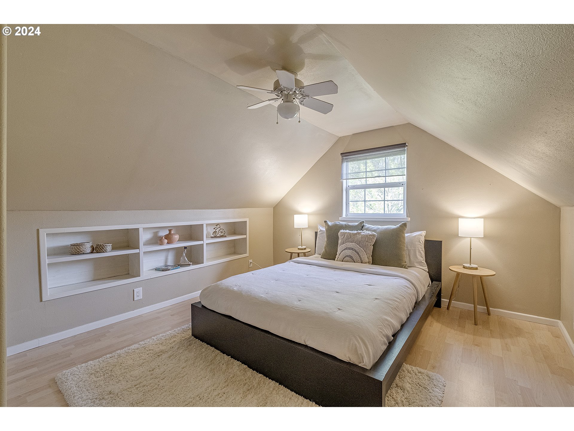 5434 Southeast King Road Milwaukie, OR 97222 - Photo 17 of 33 a bedroom with a large bed and a chandelier