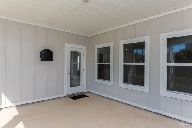 a view of an empty room with windows and wardrobe