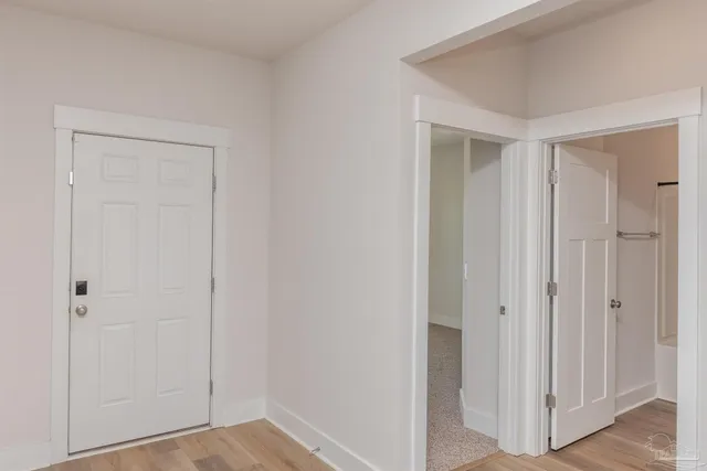 a view of a hallway with wooden floor